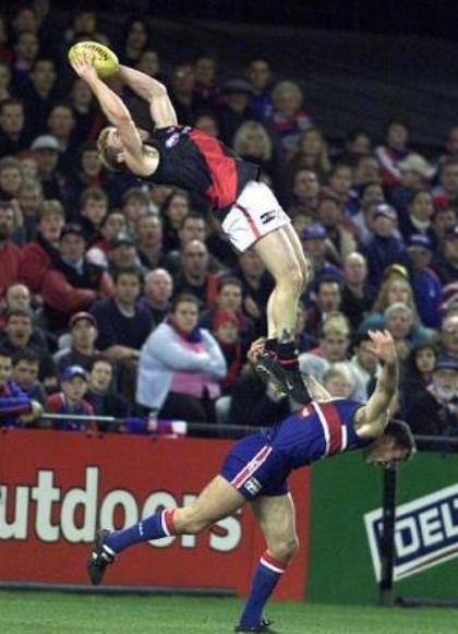 A dude flying after leaping off of the back of another dude